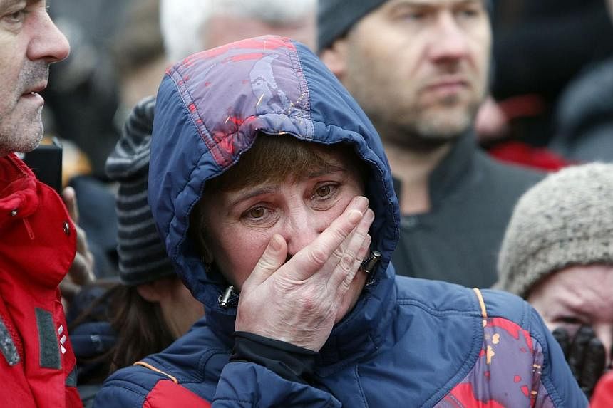 People react at the site, where Boris Nemtsov was recently murdered, in central Moscow, on Feb 28, 2015. -- PHOTO: REUTERS