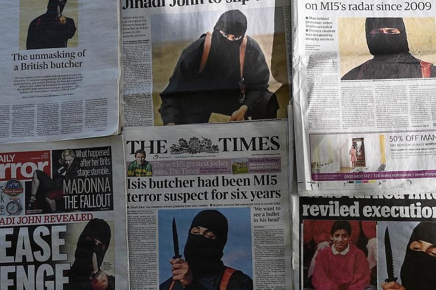 An arrangment of British daily newspapers photographed in London on Feb 27, 2015 shows the front-page headlines and stories regarding the identification of the masked Islamic State group militant dubbed "Jihadi John". -- PHOTO: AFP