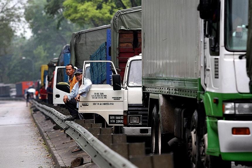 Heavy vehicles will have to be installed with more blind-spot mirrors by October to improve safety. -- PHOTO: ST FILE&nbsp;