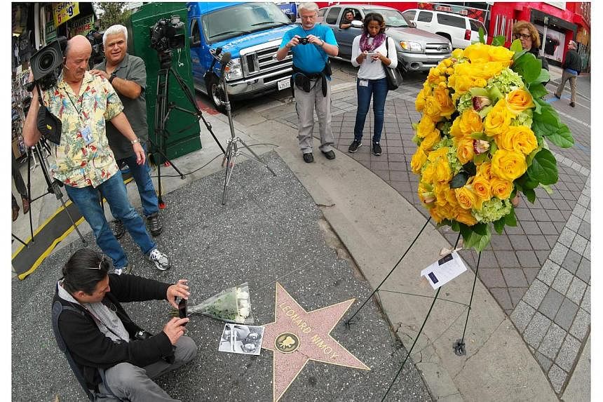 Reporters and members of the public gather at Leonard Nimoy's star on the Hollywood Walk of Fame in Hollywood, California on Feb 27, 2015. -- PHOTO: EPA