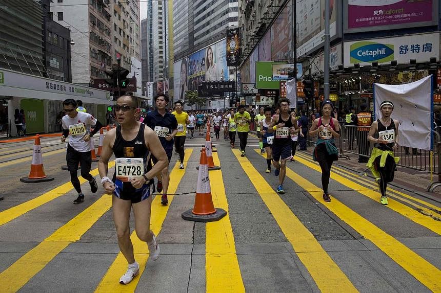 Hundreds of runners competed in Hong Kong's first inner city ultra marathon on Sunday despite a repetitive two-kilometre course which has been criticised as simply too boring. -- PHOTO: REUTERS&nbsp;