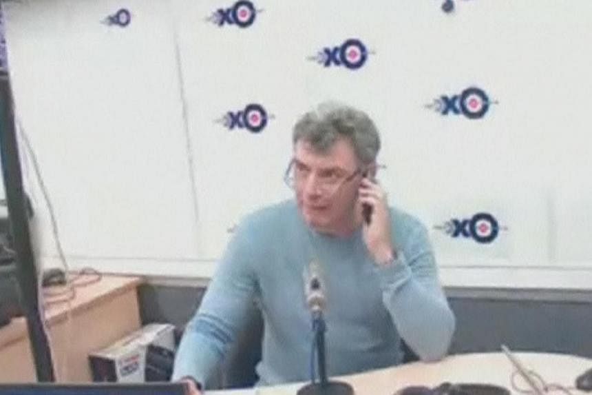 Russian opposition politician Boris Nemtsov speaks on his mobile phone before giving an interview to radio station Ekho Moskvy, hours before he was shot in Moscow in this still image from an Ekho Moskvy video on Feb 27, 2015.&nbsp;President Vladimir 
