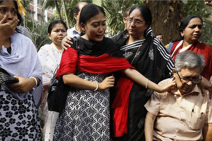 Relatives along with Ajoy Roy (right), father of Avijit Roy mourn as they pay tribute to the Bangladeshi blogger who was killed on Feb 26, 2015, in a street in Dhaka, Bangladesh, on March 1, 2015. -- PHOTO: EPA &nbsp;