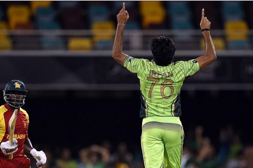 Pakistan bowler Mohammad Irfan (centre) reacts after getting the wicket of Zimbabwe batsman Solomon Mire during the 2015 Cricket World Cup Pool B match between Pakistan and Zimbabwe at the Gabba Stadium in Brisbane on March 1, 2015.&nbsp;Pakistan &nb