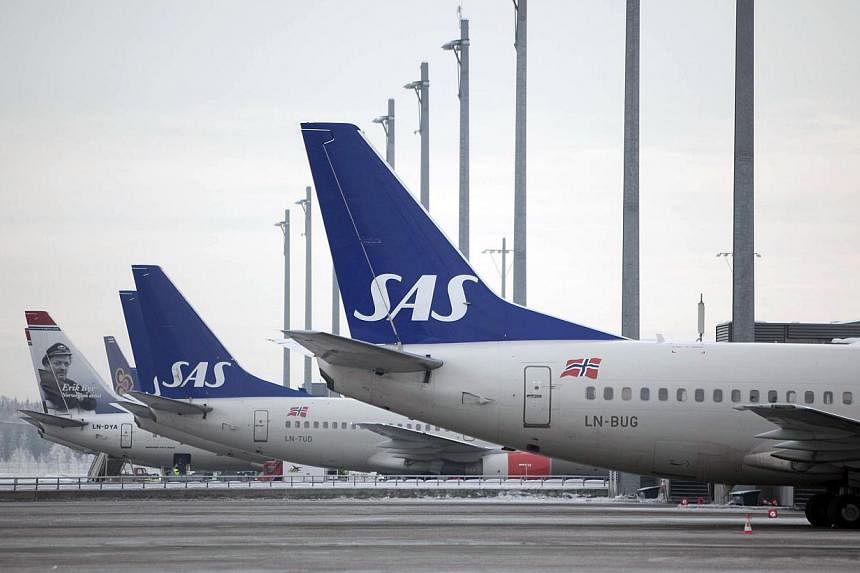Scandinavian Airlines (SAS) cancelled some 60 flights going to and from Copenhagen Airport on Saturday after members of SAS' Danish cabin staff walked out in protest over working conditions, the airline said. -- PHOTO: BLOOMBERG