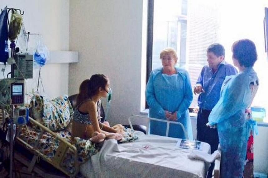 Chile's President Michelle Bachelet (third from right) on Saturday visited 14-year-old girl cystic fibrosis sufferer Valentina Maureira,&nbsp;who made a heart-wrenching video appeal to be allowed to end her life. -- PHOTO: TWITTER