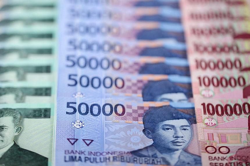 Indonesian rupiah banknotes of various denominations. The rupiah dropped to a six-year low after Bank Indonesia signalled it will tolerate a weaker currency to boost exports. -- PHOTO: BLOOMBERG&nbsp;