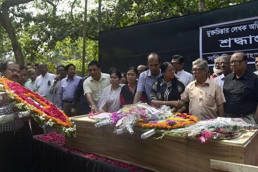 Bangladeshi mourners pay their last respects to slain US blogger Avijit Roy in Dhaka on March 1, 2015, after he was hacked to death by unidentified assailants on Feb 26.&nbsp;Bangladesh's elite security force said they had arrested an Islamist on Mon