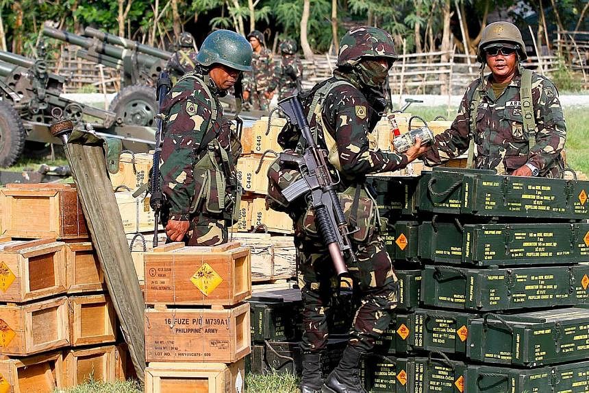 In this photo taken on Feb 28, 2015, Philippine soldiers check ammunition in Maguindanao, Southern Philippines during an offensive operation against the Bangsamoro Islamic Freedom Fighters.&nbsp;-- PHOTO: AFP