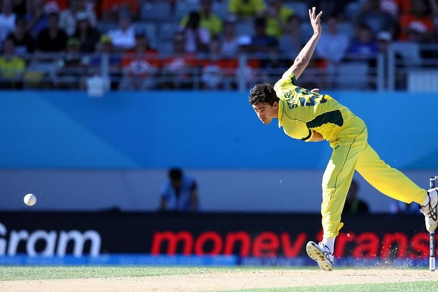 Australia's Pat Cummins bowls during the Pool A 2015 Cricket World Cup match between New Zealand and Australia at Eden Park in Auckland on Feb 28, 2015. -- PHOTO: AFP