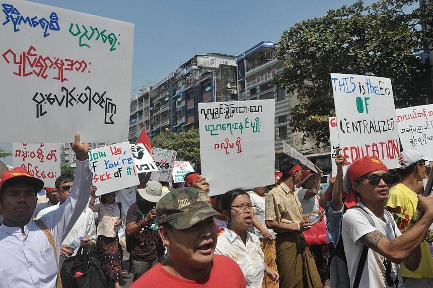 Myanmar students and nationalists hold placards as they march in protest against a national education bill in Yangon on Feb 15, 2015.&nbsp;Riot police sealed hundreds of Myanmar student protesters inside a monastery in&nbsp;Letpadan town&nbsp;on Mond