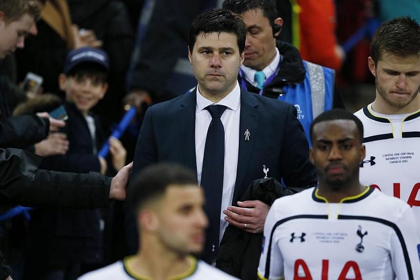 Tottenham manager Mauricio Pochettino and his players looking dejected after their League Cup final defeat to Chelsea at Wembly on March 1, 2015. -- PHOTO: REUTERS&nbsp;