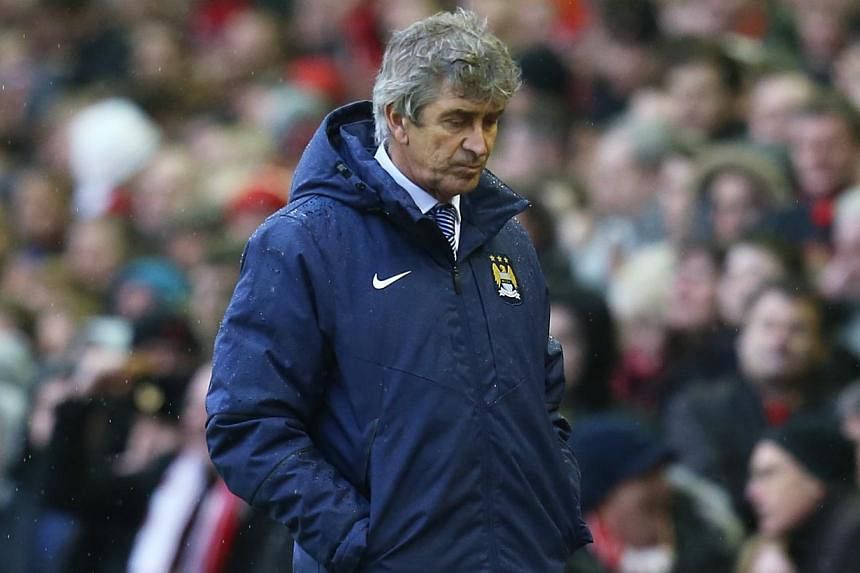 Manchester City manager Manuel Pellegrini looking dejected during his team's English Premier League match against Liverpool on Sunday, March 1, 2015. Manchester City lost 2-1. -- PHOTO: REUTERS