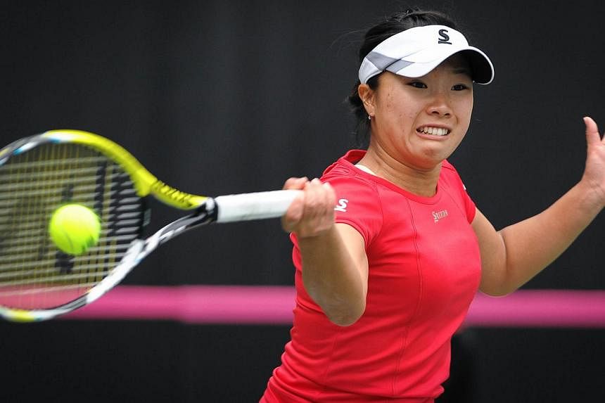 Kurumi Nara of Japan returns to Yaroslava Shvedova of Kazakhstan at the International Tennis Federation Fed Cup Asia/Oceania group match in Guangdong Olympic Tennis Centre in Guangzhou, south China's Guangdong province on Feb 7, 2015. -- PHOTO: AFP