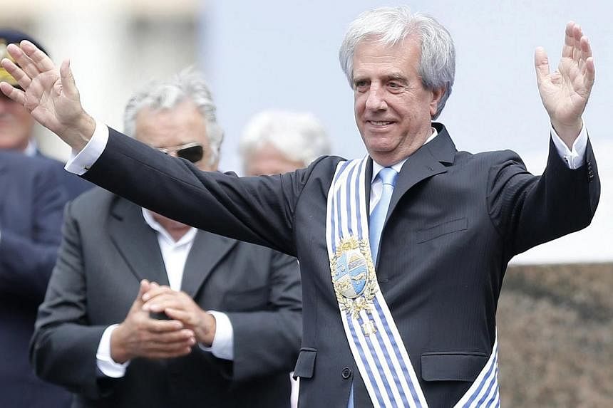 Uruguay's new president Tabare Vazquez gesturing after receiving the presidential sash from his predecessor, Jose Mujica (left, partially obscured) in Montevideo on March 1, 2015. -- PHOTO: REUTERS