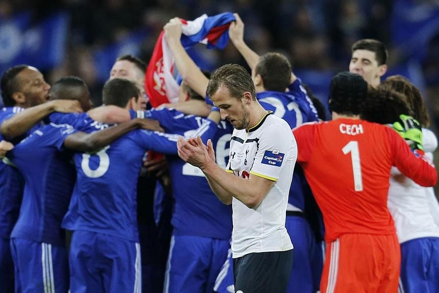 Tottenham's Harry Kane looks dejected after defeat as Chelsea players celebrate after the&nbsp;Chelsea v Tottenham Hotspur Capital One Cup Final game at the Wembley Stadium on March 1, 2015. -- PHOTO: REUTERS&nbsp;