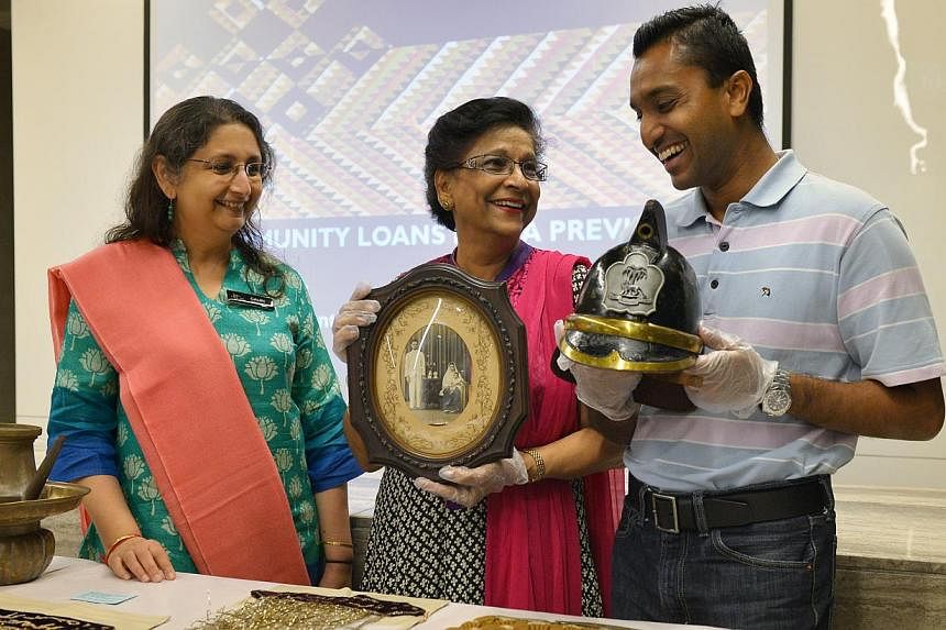 (From left) Indian Heritage Centre director Gauri Krishnan with contributors Salma Moiz and Subhas Gopal and the artifacts they are lending the Indian Heritage Centre.&nbsp;-- ST PHOTO:&nbsp;ALPHONSUS CHERN