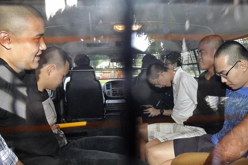 (From left) David William Graaskov, Goh Rong Liang, Chay Nam Shen, Boaz Koh Wen Jie, and Reagan Tan Chang Zhi arriving at the States Court on 10 May 2014. Chay and Tan were each given 24 months' probation on Monday. -- PHOTO: ST FILE&nbsp;