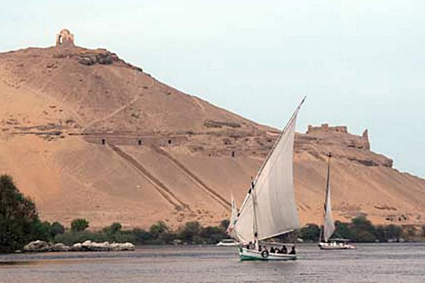A traditional Eqyptian traditional yacht called a Felucca cruises along the Nile River in Aswan, Egypt. -- PHOTO:&nbsp;Reduan Yahya