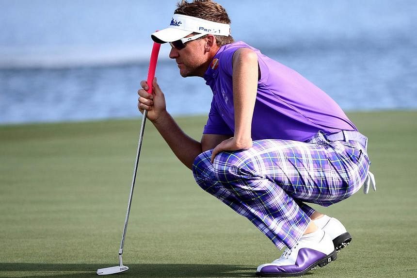 &nbsp;Ian Poulter of England lines up a putt on the 18th green during the continuation of the third round of The Honda Classic at PGA National Resort &amp; Spa - Champion Course on Sunday in Palm Beach Gardens, Florida. -- PHOTO: AFP&nbsp;