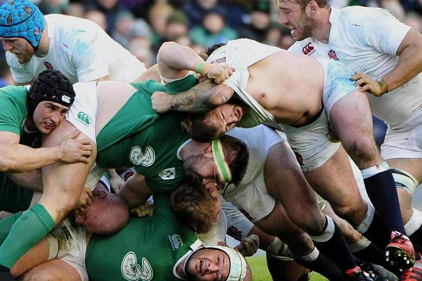 &nbsp;Ireland's Rory Best caught at the bottom of a ruck during the Six Nations Rugby match between Ireland and England in The Aviva Stadium in Dublin on Sunday. -- PHOTO: EPA