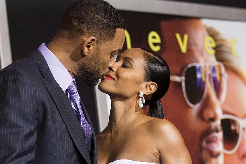Will Smith and his wife Jada Pinkett Smith kiss at the premiere of Focus last week at the TCL Chinese theatre in Hollywood, California. -- PHOTO: REUTERS