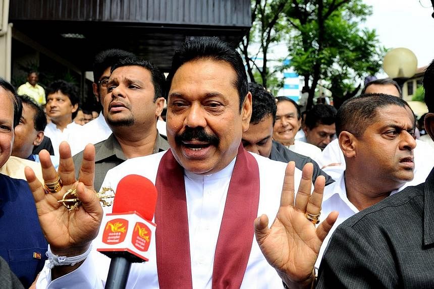 Former Sri Lankan President Mahinda Rajapakse exits the Election Commission office after handing over his nomination papers in Decembe. -- PHOTO: AFP&nbsp;