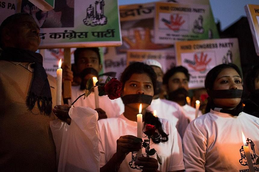 Indian political and civil society activists take part in a vigil to mark the second anniversary of the fatal gang-rape of a student in the Indian capital, at the bus stop in the Munirka area of New Delhi on Dec 16, 2014.&nbsp;One of the men convicte
