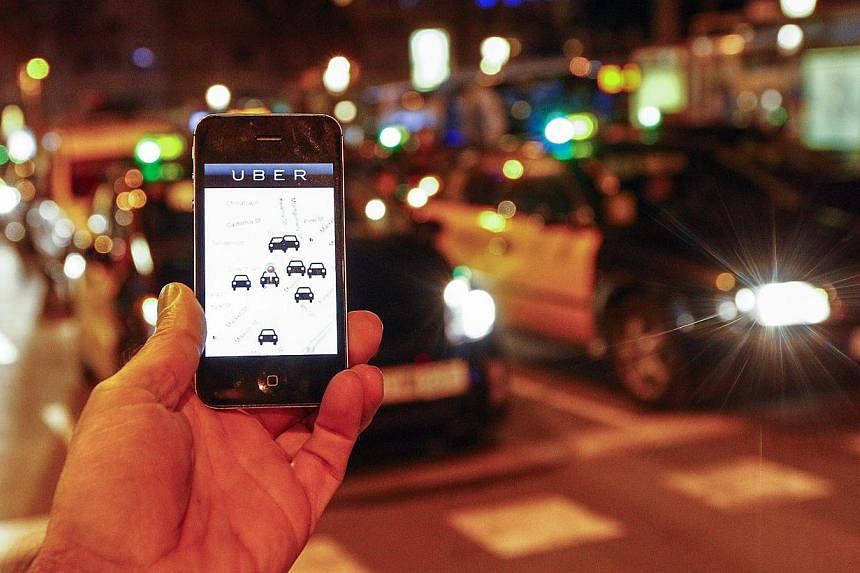 Uber helps you book a taxi or private car to take to your desired destination for a fee. -- PHOTO: AFP&nbsp;