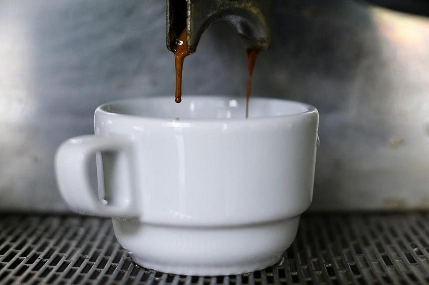 A cup of coffee is served at a coffee shop in Caracas on Feb 26, 2015.&nbsp;People who drink three to five cups of coffee a day may have a lower risk of clogged arteries that can cause serious heart problems, a study said Tuesday. -- PHOTO: REUTERS