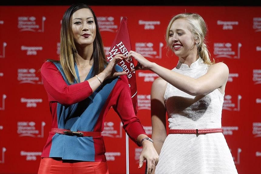 Michelle Wie (left) and Jessica Korda struck a pose during a catwalk segment of the HSBC Women's Champions press conference at Raffles City Convention Centre on March 3, 2015. -- ST PHOTO: KEVIN LIM