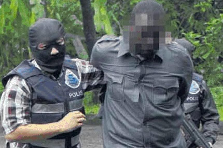 Officers from the Bukit Aman Special Branch Counter Terrorism unit detaining a terror suspect in 2014. Malaysia's new anti-terrorism act that will be tabled in Parliament this month will include provisions that allow for detention without trial and e