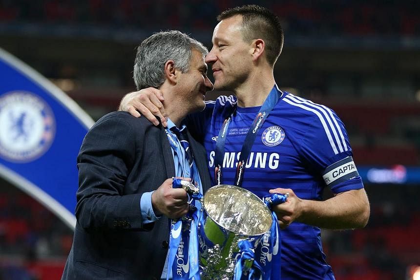 Jose Mourinho (left) has assured Chelsea fans that John Terry, subject of a "captain, leader, legend" banner that is on permanent display at Stamford Bridge, will be at the English Premier League club next season. -- PHOTO: REUTERS