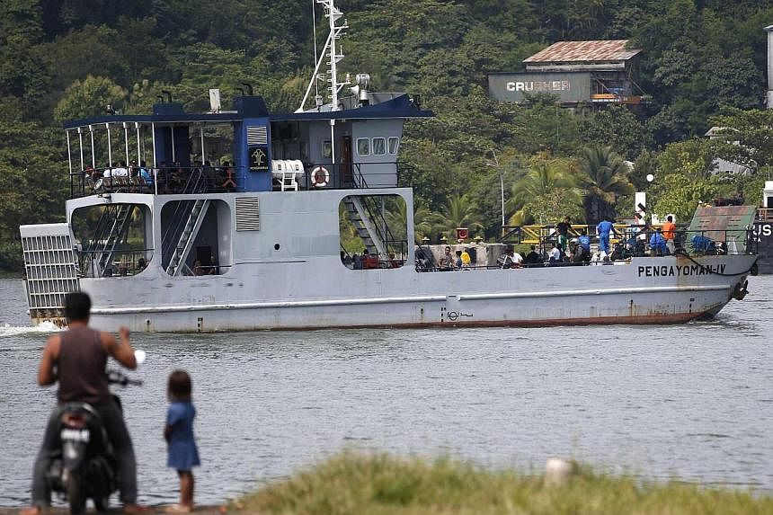 A ferry boat carrying people, including family of death row prisoners, sails to the prison island of Nusakambangan (background), where upcoming executions are expected to take place in Cilacap, Central Java on March 3, 2015.&nbsp;Two Australian drug 