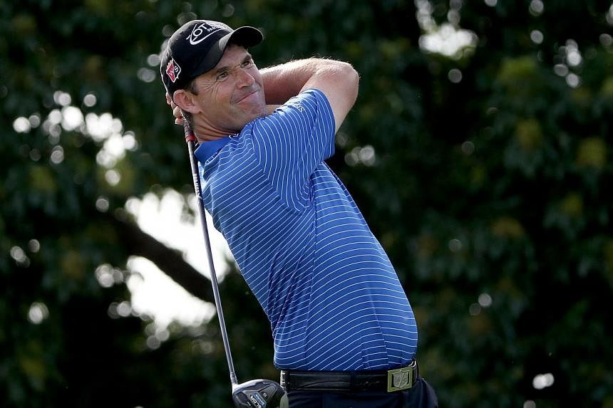 Padraig Harrington of Ireland plays his tee shot on the 14th hole during the continuation of the fourth round of The Honda Classic at PGA National Resort &amp; Spa - Champion Course on Monday in Palm Beach Gardens, Florida. -- PHOTO: AFP