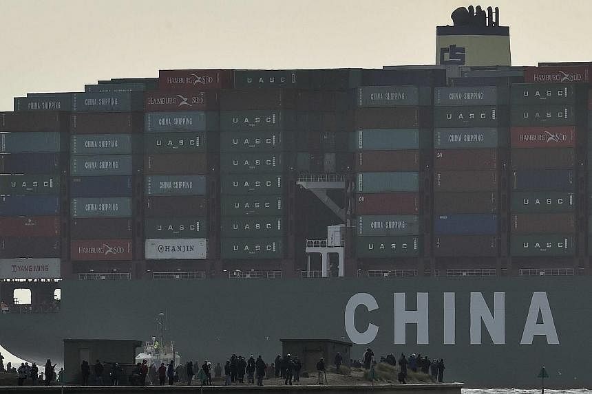 Onlookers watch from a harbour wall as the largest container ship in world, CSCL Globe, docks during its maiden voyage, at the port of Felixstowe in south east England, in this Jan 7, 2015 file photo. As global shipping grapples with its worst downtu