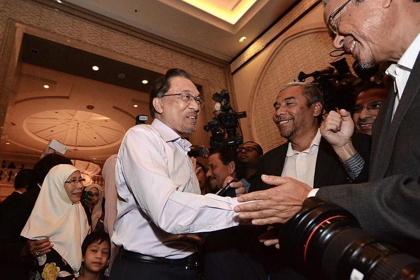 Malaysian opposition leader Anwar Ibrahim (centre) and his wife Wan Azizah (back left) arrive at the Federal Court ahead of a ruling on his appeal of a sodomy conviction in Putrajaya, outside Kuala Lumpur on Feb 10, 2015. An appeal for Anwar to atten