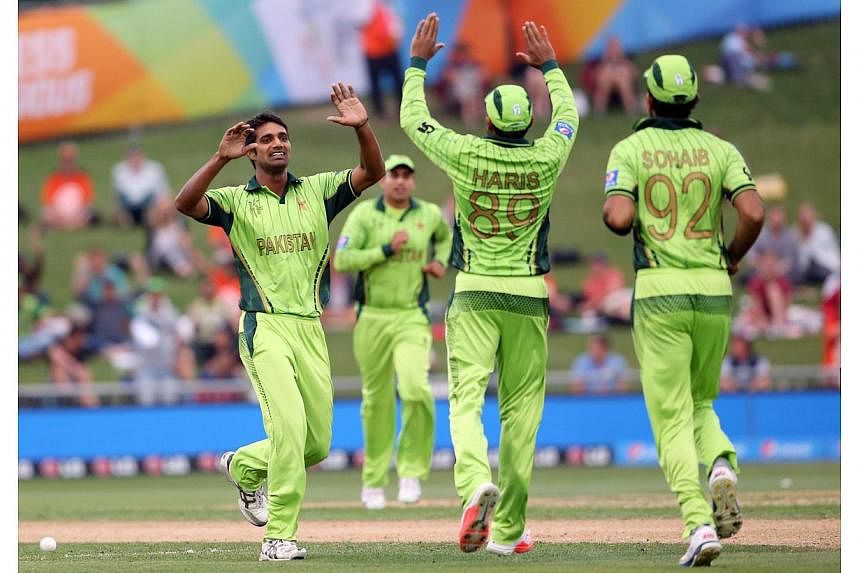 Pakistan's Rahat Ali (left) celebrates the wicket of UAE's Amjad Ali during the Pool B Cricket World Cup match between the United Arab Emirates (UAE) and Pakistan at McLean Park in Napier on March 4, 2015. -- PHOTO: AFP&nbsp;