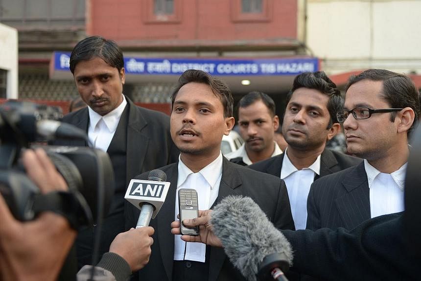 Indian lawyer Alok Dwivedi (centre), who represents Uber taxi driver Shiv Kumar Yadav, who has been accused of the rape of a female passenger, speaks to media outside the Tis Hazari District court in New Delhi on Jan 15, 2015.&nbsp;An Indian court on