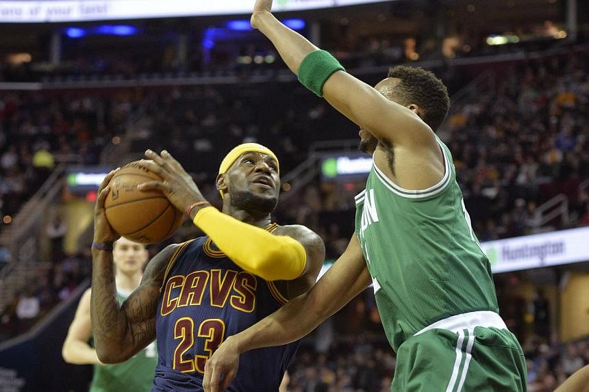 Cleveland Cavaliers forward LeBron James (#23) drives against Boston Celtics guard Evan Turner (#11) in the first quarter at the Quicken Loans Arena in Cleveland, Ohio, on March 3, 2015. -- PHOTO: DAVID RICHARD - USA TODAY SPORTS