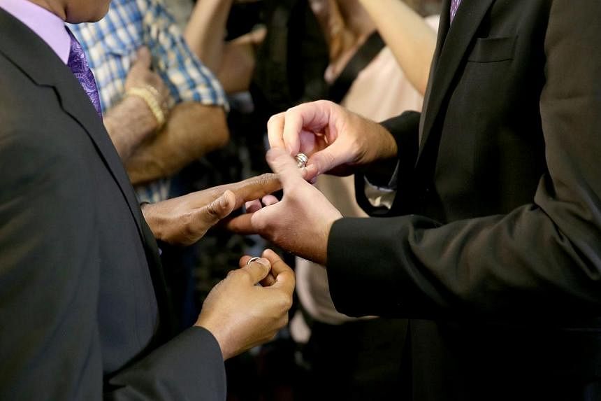 Newlyweds exchange rings during a gay marriage ceremony in the US state of Miami on Jan 5, 2015.&nbsp;A California lawyer has submitted a referendum proposal to outlaw homosexuality in the famously liberal western US state, on pain of execution. -- P