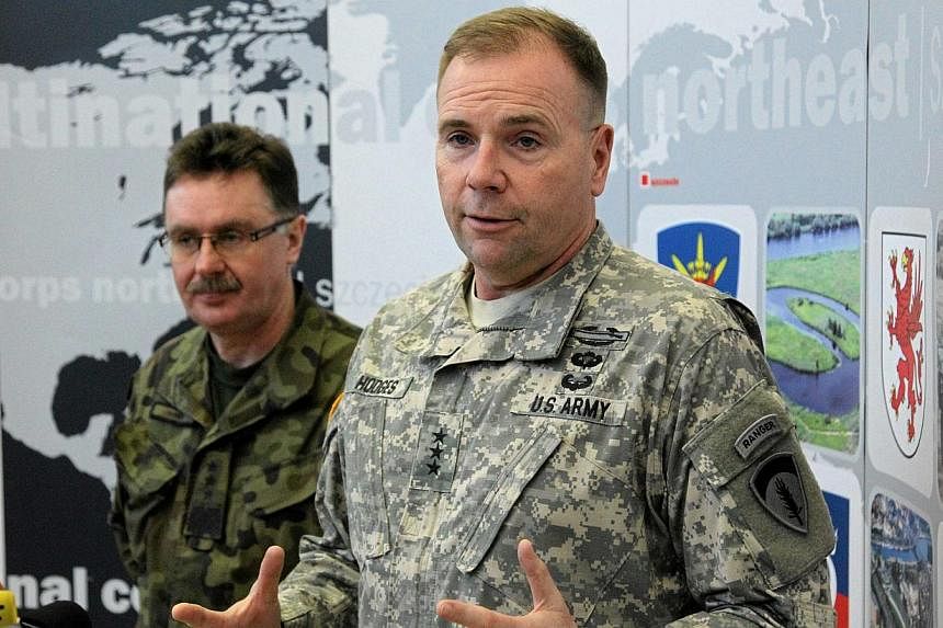 The US military estimates around 12,000 Russian soldiers are supporting pro-Moscow separatists in eastern Ukraine, US Army Europe commander Ben Hodges (above right) said on Tuesday. -- PHOTO: REUTERS