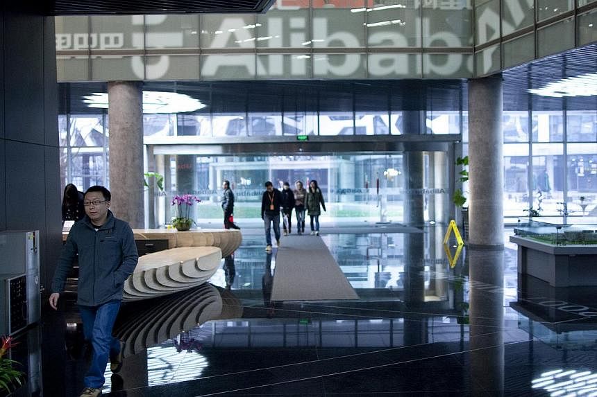 People walk through Alibaba's headquarters in Hangzhou, Zhejiang Province, China. The Internet company is launching a cloud computing hub in Silicon Valley on Wednesday, the e-commerce giant's first outside of China, underscoring its global ambitions