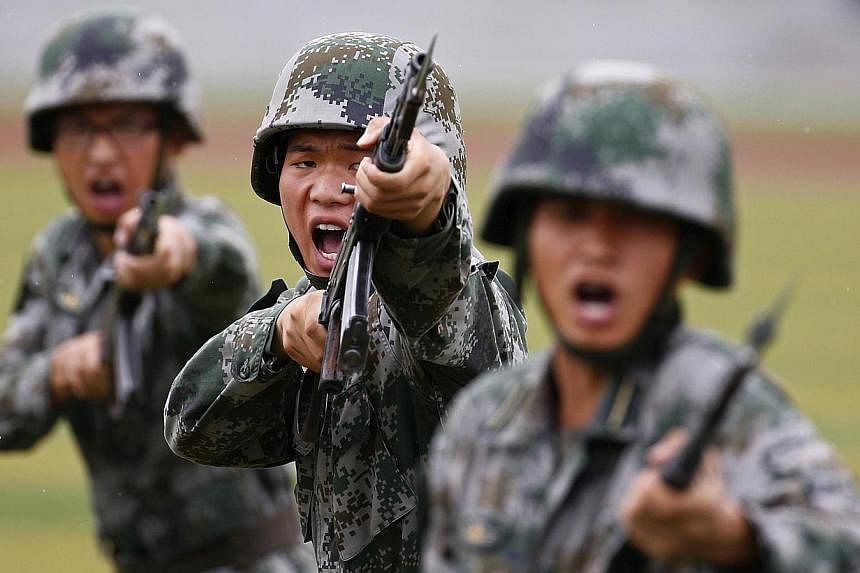 China’s defence budget this year will rise about 10 per cent compared with 2014, a spokesman for the country’s parliament said on Wednesday. -- PHOTO: REUTERS