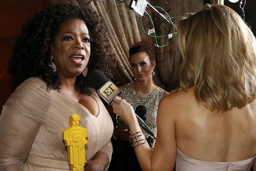 Oprah Winfrey holds a lego Oscar statue while being interviewed at the Governor's Ball following the 87th Academy Awards in Hollywood, California on Feb 22, 2015. Winfrey announced on Tuesday that she will be shutting down Harpo Studios in Chicago af