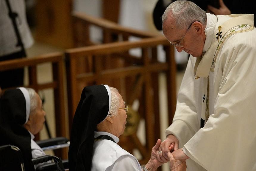 Pope Francis greeting elderly nuns while celebrating mass with bishops and priests at the Manila cathedral on Jan 16, 2015. The Pope has urged his followers&nbsp;to show affection and respect for the elderly, saying they must not be treated as "alien