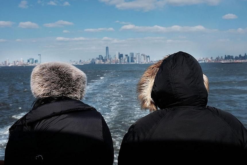 The New York skyline as seen from the Staten Island ferry on Feb 19, 2015.&nbsp;Rent will gobble up nearly 60 per cent of New Yorkers' income in 2015 with the median cost of an apartment to rise to US$2,700 (S$3,680) a month, a real-estate website sa