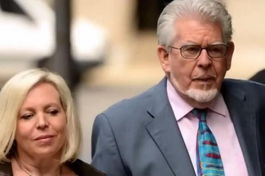 Britain's Queen Elizabeth has stripped veteran entertainer Rolf Harris (above right) of an honour she bestowed on him in 2006, basing the move on his conviction for child sex crimes last year, an official notice on Tuesday revealed. -- PHOTO: YOUTUBE