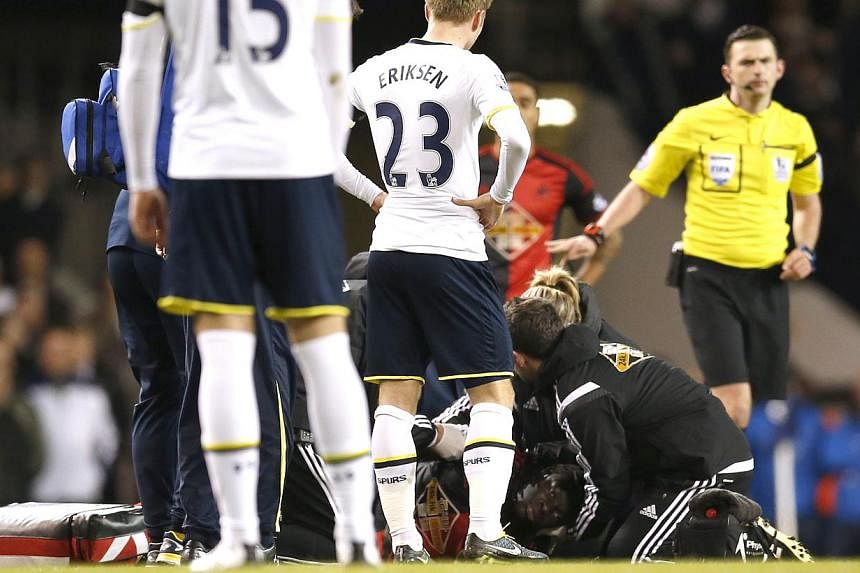 Swansea's Bafetimbi Gomis receives medical attention after sustaining an injury during his match against Tottenham Hotspur at the&nbsp;Barclays Premier League in White Hart Lane on March 4, 2015. -- PHOTO: REUTERS