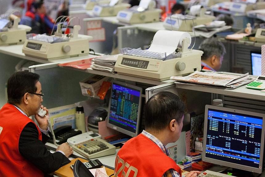 Stock traders on the floor of the Hong Kong stock exchange on Feb 23, 2015. China plans on linking up the Shenzhen and Hong Kong stock exchanges on a trial basis as part of its financial sector reform. -- PHOTO: EPA&nbsp;